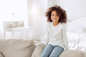 Smiling child sitting on a sofa