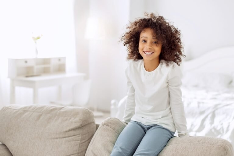 Smiling child sitting on a sofa